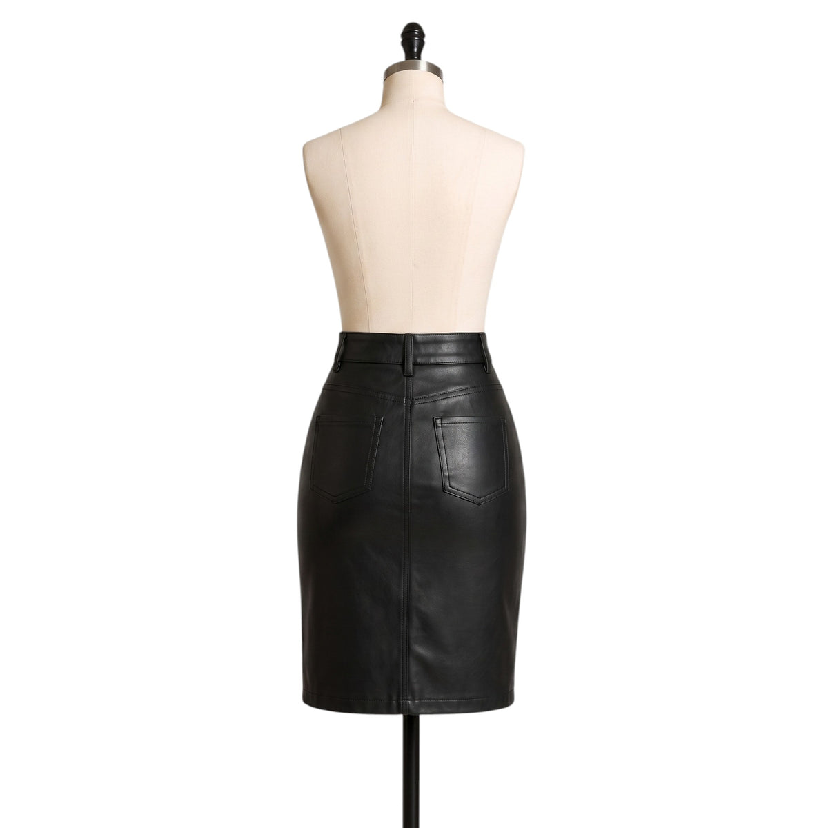 "Full back view of the black leather pencil skirt on a mannequin, showing both back pockets, belt loops, and the waistband against a white background."