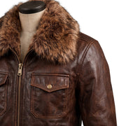 "Close-up of the fur collar and chest pocket on a dark brown distressed leather bomber jacket, showing the fur texture and button-flap pocket detail."