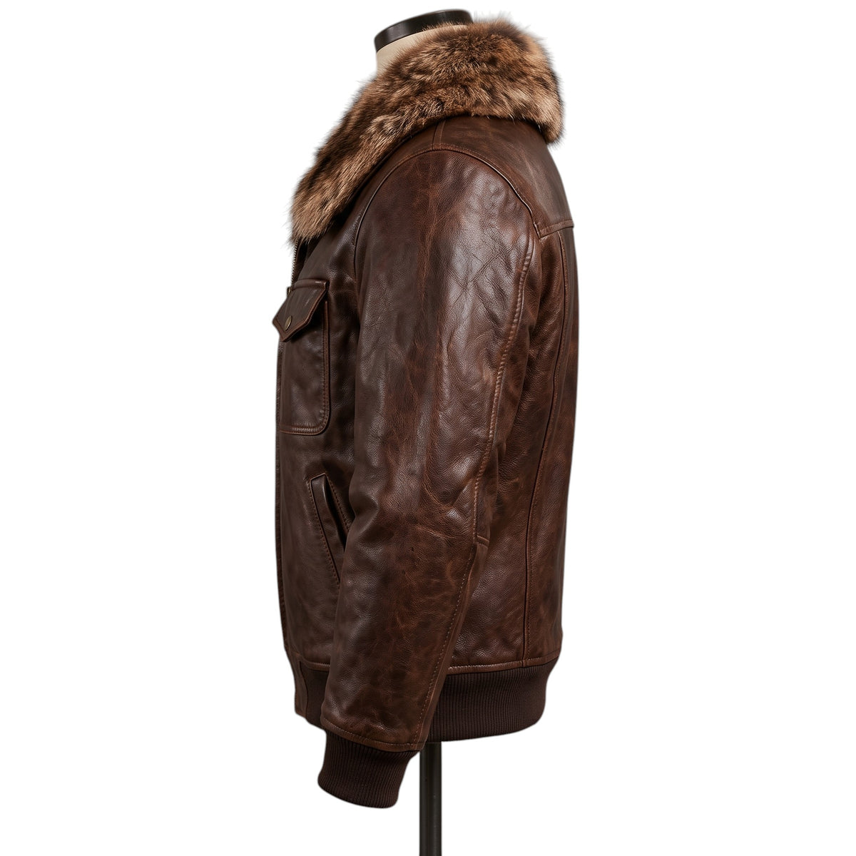 "Opposite side profile view of a dark brown distressed leather bomber jacket on a mannequin, showing the fur collar, chest and side pockets, and ribbed cuffs against a white background."