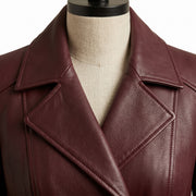 **"Close-up of burgundy leather coat's notched lapel collar and stitching"**