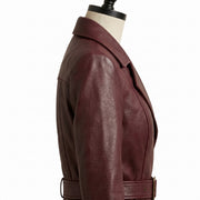 **"Close-up side view of burgundy leather coat's collar and belt buckle"**