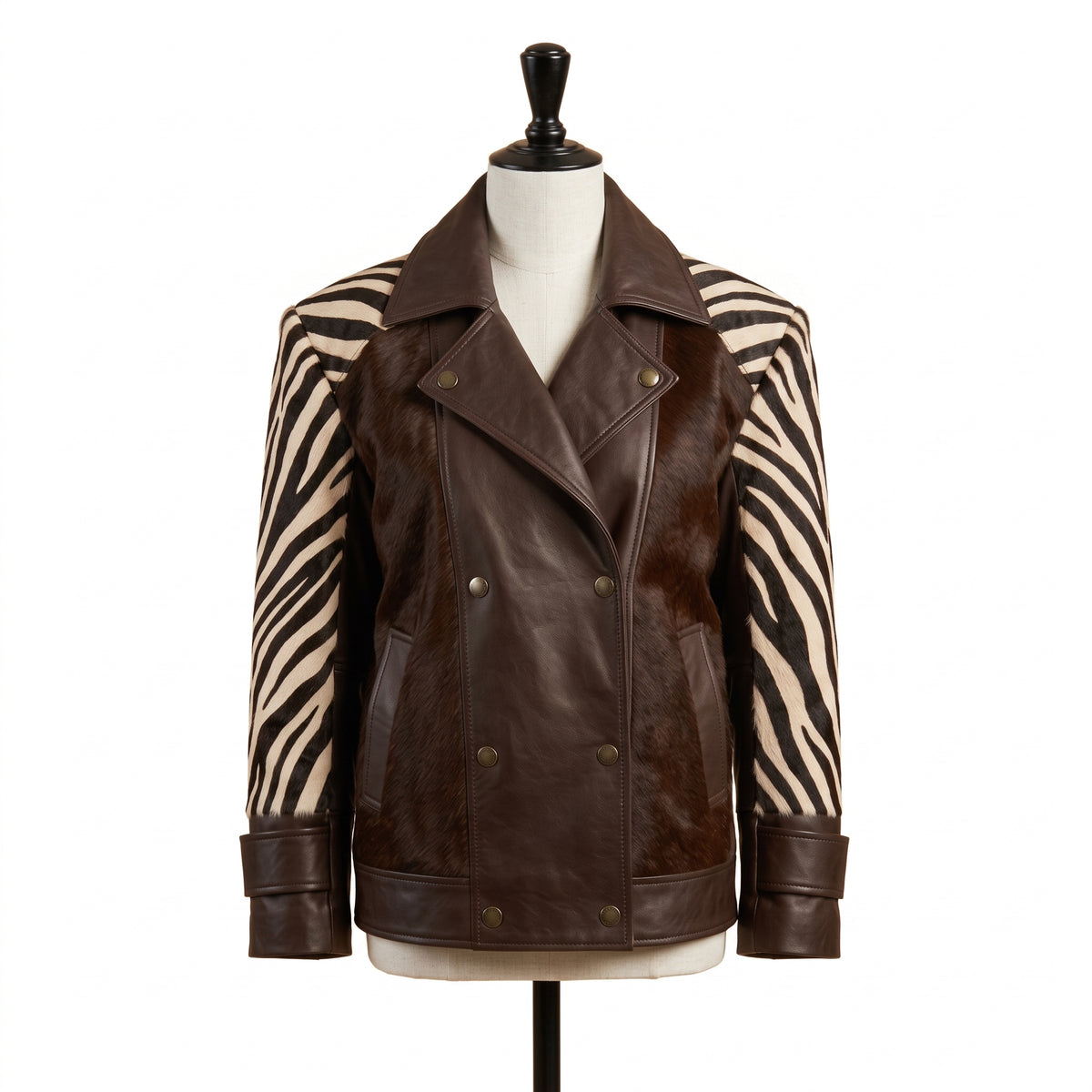 A dark brown leather jacket with zebra-print sleeves, displayed on a mannequin torso against a white background.