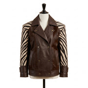 A dark brown leather jacket with zebra-print sleeves, displayed on a mannequin torso against a white background.
