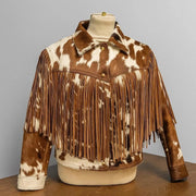 "Cowhide print fringe jacket, front view, with snap buttons and cuffed sleeves on mannequin display."